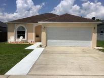 Charming single-story home featuring a manicured lawn, two-car garage and inviting entryway at 2057 Swift Rd, Oviedo, FL 32766