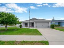 Charming single-Gathering home with a manicured lawn, two car garage and welcoming curb appeal at 305 St Georges Cir, Eagle Lake, FL 33839