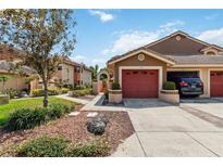 Charming townhome featuring a single-car garage, nicely landscaped yard, and warm color palette at 7759 Sugar Bend Dr # 7759, Orlando, FL 32819