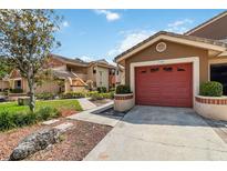 Charming townhome featuring a well-manicured lawn, attached garage, and inviting curb appeal at 7759 Sugar Bend Dr # 7759, Orlando, FL 32819