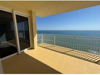 Spacious balcony showcasing ocean views with white railings and large glass sliding doors at 2300 N Atlantic Ave # 1502, Daytona Beach, FL 32118