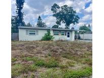 Modest single-story home with a flat roof, small windows, and front yard overgrown with weeds at 606 El Vedado Ave, Orlando, FL 32807