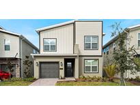 Modern two-story home with neutral siding, a one-car garage, and a well-manicured front yard at 3008 Protagonist St, Kissimmee, FL 34746
