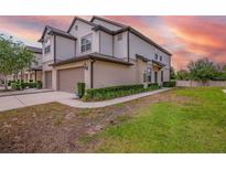 Attractive townhome exterior features two-car garage, neutral colors, and manicured landscaping at 1101 Pavia Dr, Apopka, FL 32703