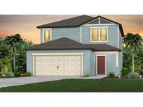 Charming two-story home with blue siding, a two-car garage, and a well-manicured lawn at 9048 Wildlight Trl, Wildwood, FL 34785