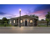 Charming home featuring a cozy front porch, meticulous landscaping, and a classic lamp post at 1101 Dr Martin L King Jr Way, Haines City, FL 33844