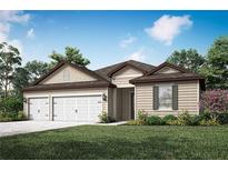 Charming single-story home featuring a three-car garage, manicured lawn, and beautiful landscaping at 2649 Sw 176Th Loop, Ocala, FL 34473