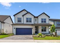 Charming two-story home with stone accents, landscaped yard, and a two-car garage at 16994 Cedar Valley Cir, Clermont, FL 34711