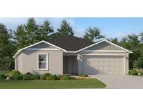 Charming single-story home featuring a well-maintained lawn and attached two-car garage at 2438 Mckinley Dr, Lake Wales, FL 33859