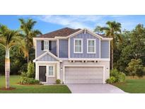 Charming two-story home showcasing a modern design, attached garage, and lush landscaping at 5621 Gingham Dr, Kissimmee, FL 34758