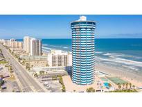Stunning exterior view of the beachfront condominium tower with ocean views and surrounding city buildings at 2625 S Atlantic Ave # 24Sw, Daytona Beach, FL 32118