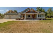 Charming single-Gathering home with a welcoming front porch and a spacious two-car garage at 4004 Se 47Th Pl, Ocala, FL 34480