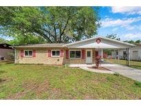 Charming single-story brick home with red shutters and carport at 1123 Enchanted Dr, Lakeland, FL 33801