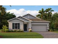 Charming single-story home with a two-car garage, well-maintained lawn, and beautiful landscaping at 2853 Haze Rd, Clermont, FL 34714