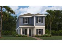 Charming two-story home featuring a stylish blue exterior, complemented by a well-maintained lawn and lush landscaping at 2899 Transformation Way, Clermont, FL 34714