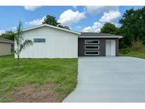 Charming home with a contemporary two-tone exterior and a well-manicured front yard at 481 S East Ave, Bartow, FL 33830