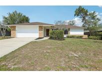 Charming single-story home with brick accents, well-maintained lawn, and attached two-car garage at 2791 Citron Dr, Longwood, FL 32779