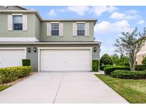 Charming two-story home with a large white garage door, well-manicured lawn and neatly trimmed hedges at 3550 Rodrick Cir, Orlando, FL 32824