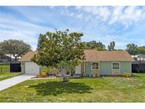 Charming single-story home with a well-maintained lawn, stone accents, and a mature tree in the front yard at 4727 Wales St, Lake Wales, FL 33859