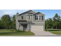 Charming two-story home featuring a gray exterior, well-manicured lawn, and an attached two-car garage at 978 Hour Glass Rd, Lakeland, FL 33801