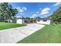Charming single-story home featuring well-maintained lawn, large driveway, and solar panels at 4821 S Gachet Blvd, Lakeland, FL 33813