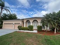Charming single-story home featuring a manicured lawn and a three car garage at 2163 Wintermere Pointe Dr, Winter Garden, FL 34787