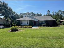 Well-maintained single-story home featuring a brick facade and a neatly manicured lawn at 2528 Deerbrook Dr, Lakeland, FL 33811