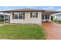 Charming single-story home featuring a well-maintained lawn and neutral siding with complementary brown shutters at 4846 Colonnades Club Blvd, Lakeland, FL 33811