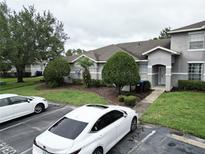 Well maintained townhouse featuring manicured landscaping and reserved parking at 13140 Summerton Dr, Orlando, FL 32824