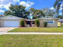 Charming single-story home featuring a well-manicured lawn, classic design, and attached garage at 5532 Stull Ave, Orlando, FL 32810