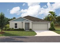 Charming single-story home featuring a two-car garage, manicured lawn, and inviting front entrance at 1621 Sage Ave, Haines City, FL 33844