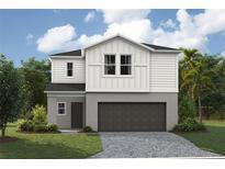 Charming two-story home featuring a craftsman-style design, a two-car garage, and a well-maintained lawn at 4039 Gardenia Ave, Lake Hamilton, FL 33851