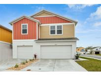 Charming two-story home featuring a two-car garage and colorful, eye-catching design at 3762 King Hill Dr, Haines City, FL 33844