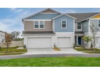 Charming townhome featuring a two-car garage and modern exterior design at 3782 King Hill Dr, Haines City, FL 33844