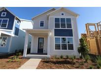 Charming two-story home with a modern design, large windows, and a welcoming front porch at 6690 Wake St, St Cloud, FL 34771