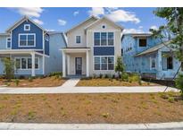 Charming two-story home with blue accents and a well-maintained front yard at 6690 Wake St, St Cloud, FL 34771