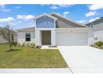 Charming single-Gathering home featuring a modern exterior with a two-car garage and well-maintained lawn at 5933 Slate Rock Dr, Lakeland, FL 33811