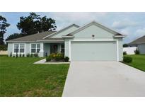 Charming one-story home boasts a manicured lawn and attached two-car garage at 206 Samantha Ave, Auburndale, FL 33823