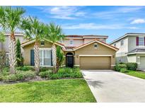 Charming single-Gathering home featuring a well-manicured lawn and beautiful palm trees at 5247 Wildwood Way, Davenport, FL 33837