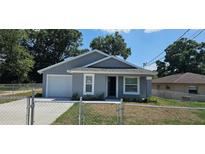 Charming single-story home featuring a well-maintained lawn and a classic architectural design at 1318 Herschell St, Lakeland, FL 33815