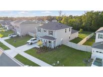 Two-story home with a well-manicured lawn, attached garage, and a long driveway for ample parking at 5189 Greenheart Ave, Mount Dora, FL 32757