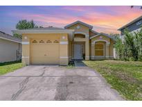 Charming one-story home featuring an attached garage and inviting front entrance with a well-maintained lawn at 1309 Timberbend Cir, Orlando, FL 32824