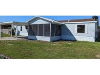 Charming single Gathering home featuring a screened lanai and spacious carport at 4300 Meadow Ridge Ave, Mulberry, FL 33860