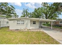 Charming single-story home with a covered carport and well-maintained front lawn at 728 Trenton Rd, Lakeland, FL 33815
