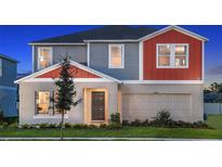 Charming two-story home with a well-manicured lawn and an attached two-car garage at 1609 Sage Ave, Haines City, FL 33844