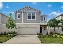 Inviting two-story home with a well-manicured lawn and attached two-car garage at 4035 Gardenia Ave, Lake Hamilton, FL 33851