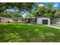 Charming single-story home with a well-manicured lawn and tasteful landscaping at 811 Patricia Pl, Lakeland, FL 33809