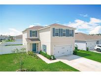 Charming two-story home with blue shutters, landscaped yard, and attached two car garage at 1508 Majestic Ln, Winter Haven, FL 33880