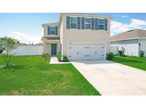 Charming two-story home features a well-manicured lawn and a two car garage at 1508 Majestic Ln, Winter Haven, FL 33880