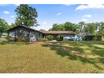 Charming single-story home boasts a well-manicured lawn, mature trees, and inviting curb appeal at 19795 Sw 85Th Loop, Dunnellon, FL 34432